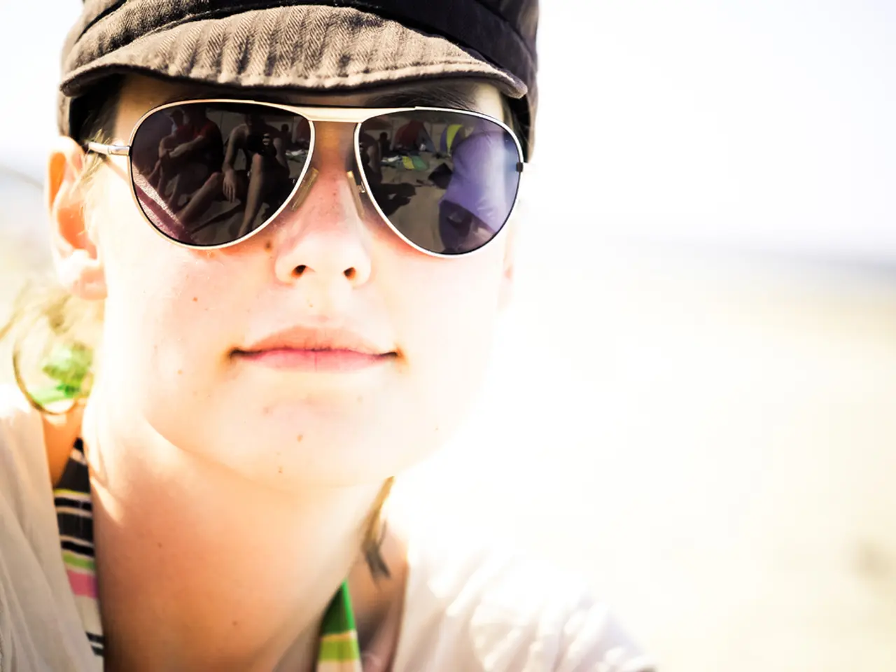 A woman is there, she wore goggles, cap and a white color t-shirt.