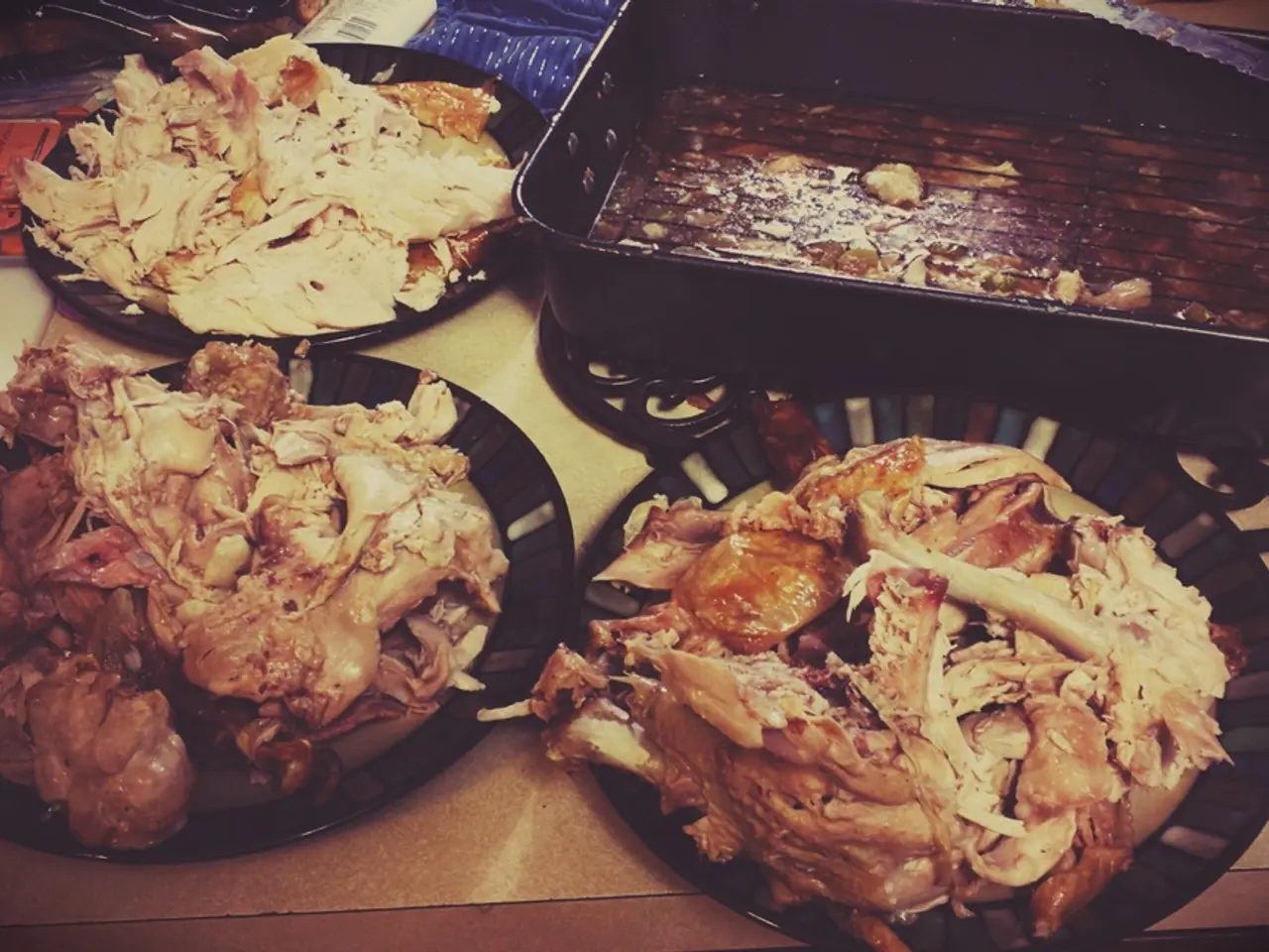 In this image there is a table on that table there are bowls, in that bowls there is meat.