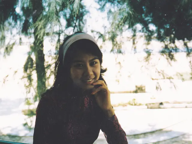 In the center of the image, there is a girl sitting and smiling and wearing a head band and in the...