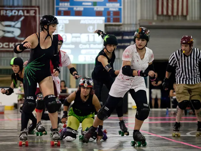 In this image there is a woman kneeling on the floor. There are people wearing the skates. They are...