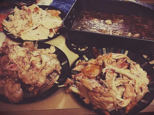 In this image there is a table on that table there are bowls, in that bowls there is meat.