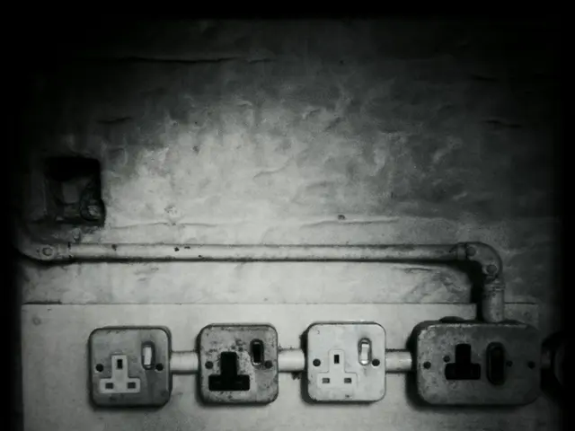 In this picture I can see the sockets and a pipe on the wall. I see that this is a black and white...